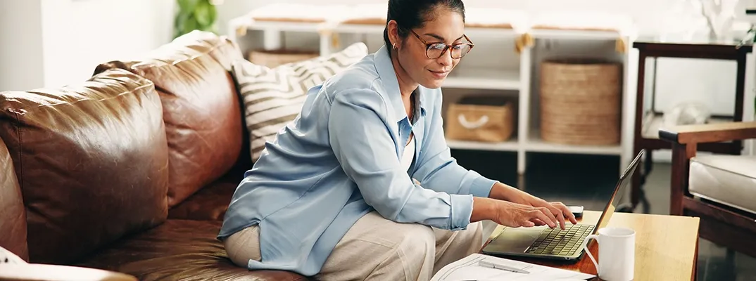 A woman typing on a laptop