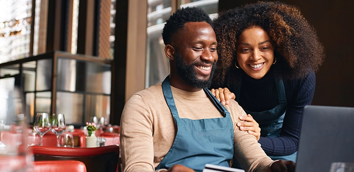 Two diner owners looking at a laptop