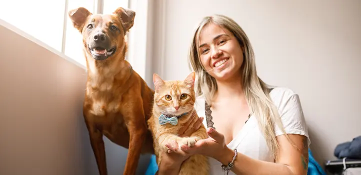 A woman with a dog and cat