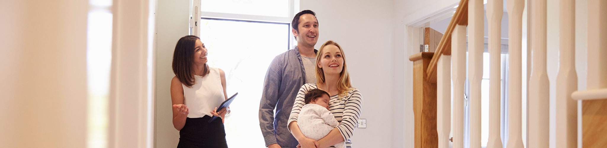 A landlord shows a family a rental home