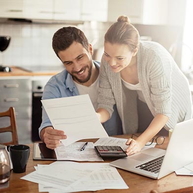 Young couple looking at budget in home