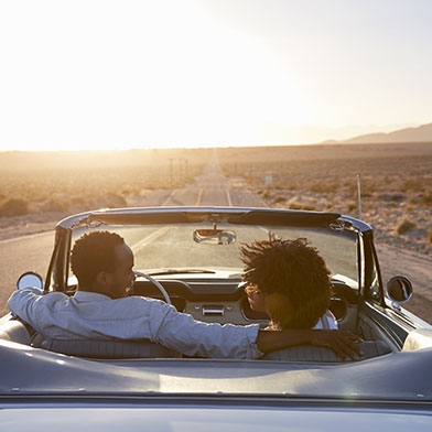 Couple riding in a convertible