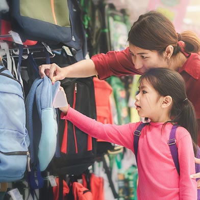 Mom and daughter shopping for a new backpack