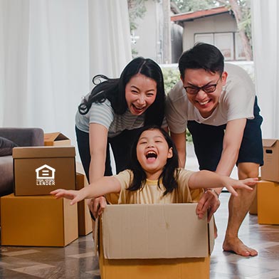 Family playing with moving boxes while moving into their new home