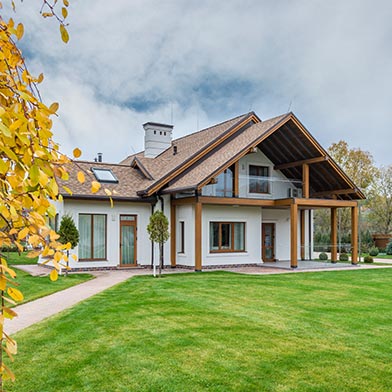 Exterior photo of home with fall trees around