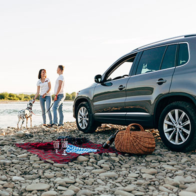 Couple Riverside With New Car