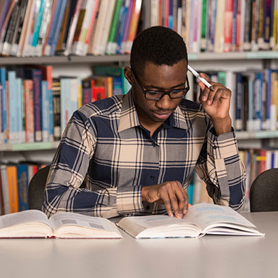 College student sitting in library, studying