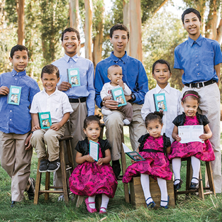 The Maki family shows off their Sunward Savings Laboratory notebooks