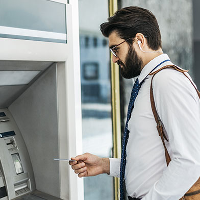 Business man using ATM