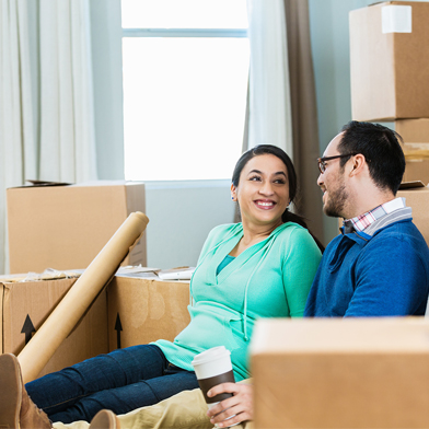 A couple takes a break from moving into a new home