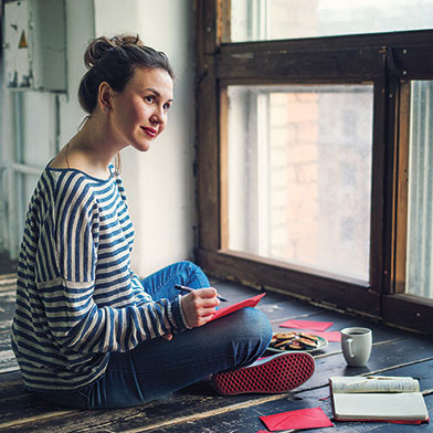 Woman writing on holiday card