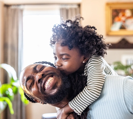 A father giving his daughter a piggyback ride